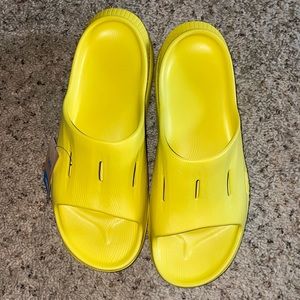 Yellow Hoka slides